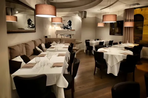 Sala del Target Restaurant con i tavoli apparecchiati di bianco